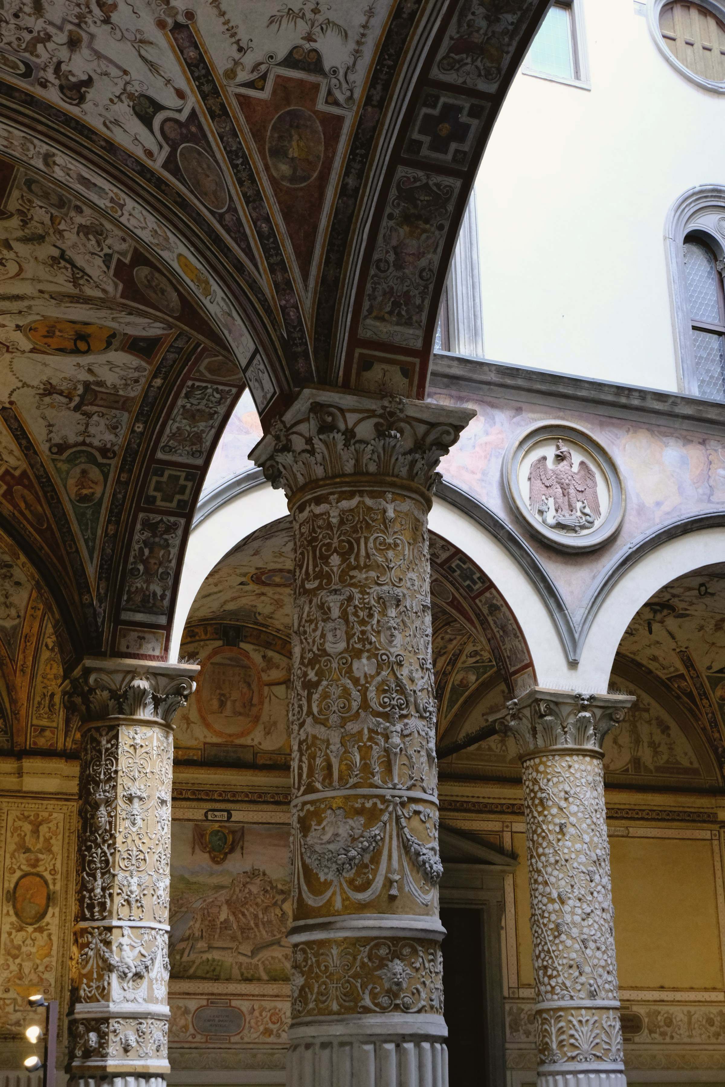 Carved Renaissance columns and arches around a Florentine courtyard
