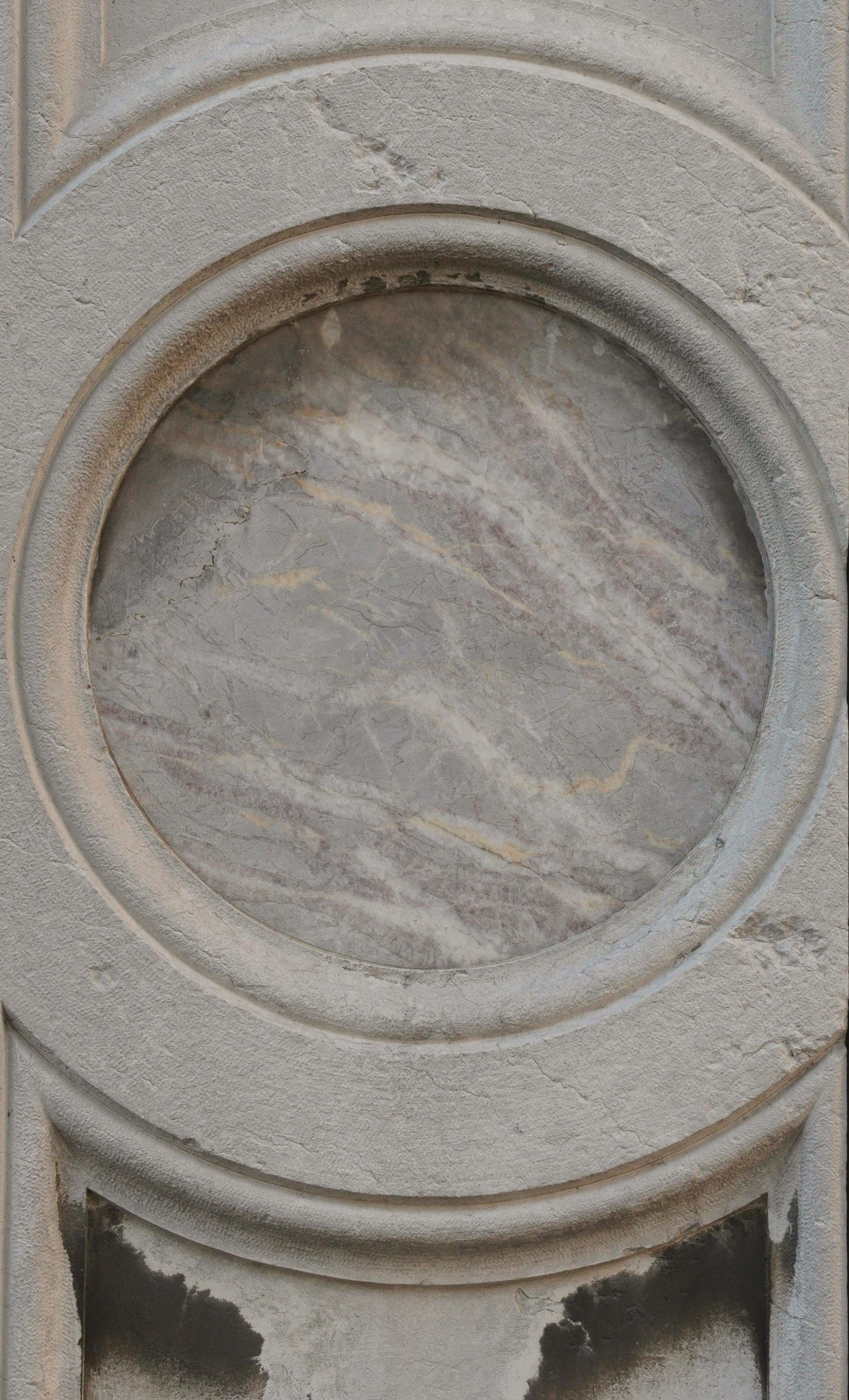 A carved roundel of grey sandstone
